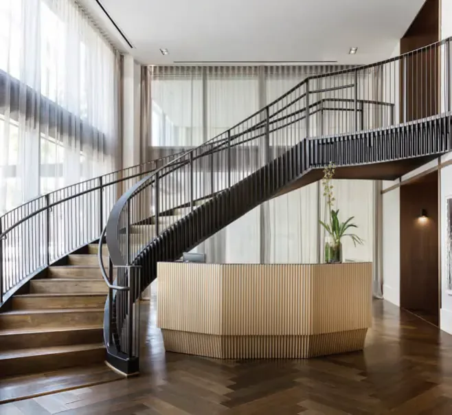 Stone flooring and staircase applications coordinated within an interior