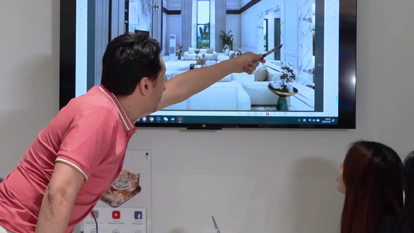 Interior designer reviewing a floor plan and project drawings